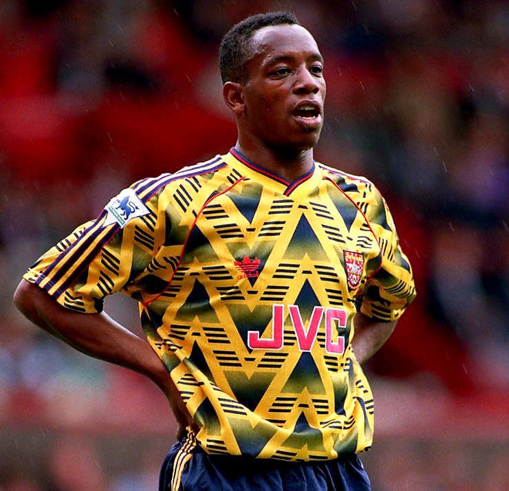 Ian Wright on the pitch wearing the bruised banana, yellow arsenal kit with JVC sponsor of the 90s.