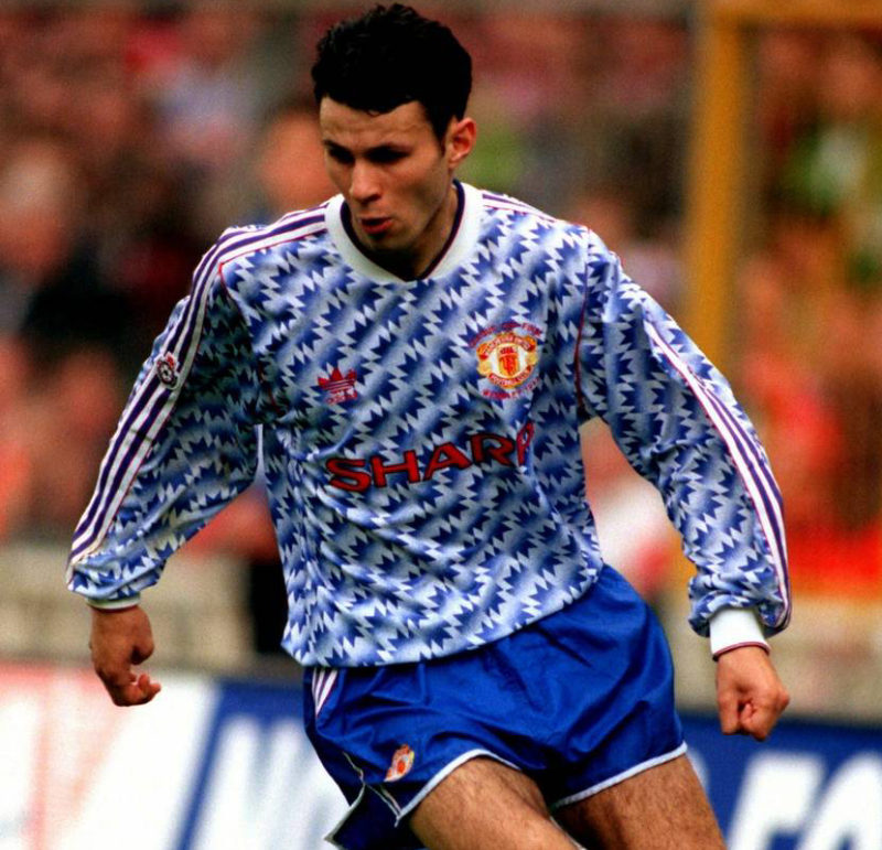 Giggs on the pitch while wearing baby blue patterned man united kit of the 90s.